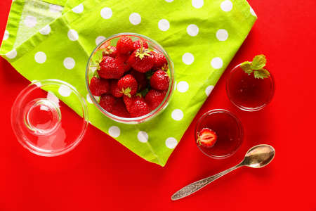 Bowls of tasty strawberry jam on color backgroundの写真素材
