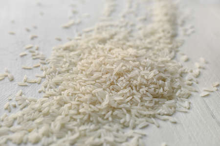 Heap of rice on white tableの写真素材
