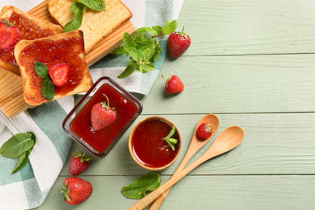 Bread with tasty strawberry jam on table