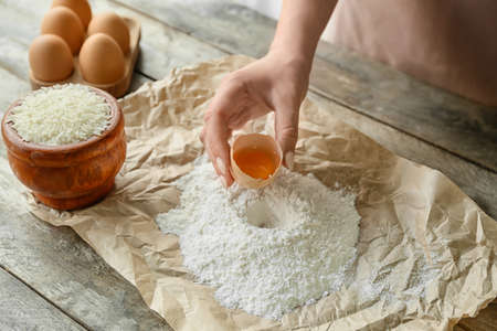 Woman making rice dough at table