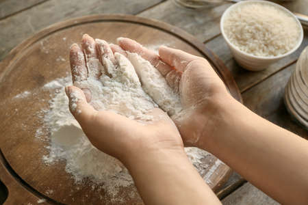 Woman with rice flour at table