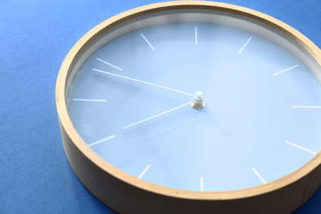 Simple clock on color background, closeup