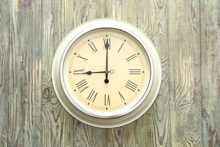 Simple clock on wooden backgroundの写真素材