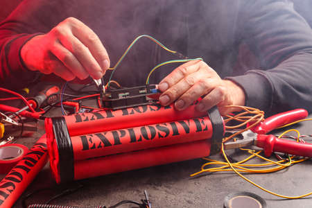 Terrorist making bomb at table