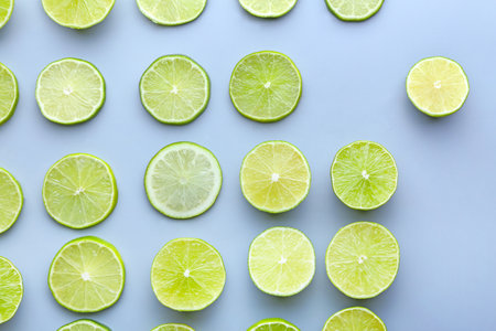 Fresh lime slices on light backgroundの写真素材