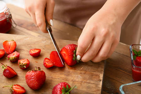 Woman making sweet strawberry jam in kitchen, closeupの写真素材