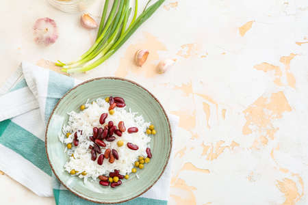 Plate with tasty rice, beans and peas on white backgroundの写真素材