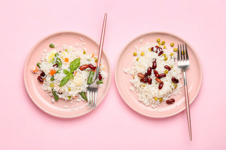 Plates with tasty rice, beans and vegetables on color backgroundの写真素材