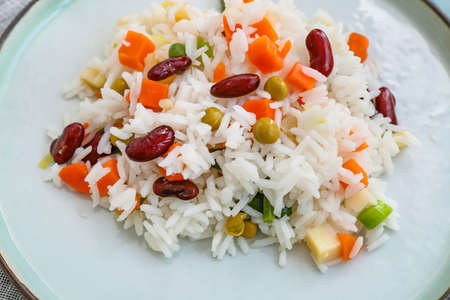 Plate with tasty rice, beans and vegetables, closeup