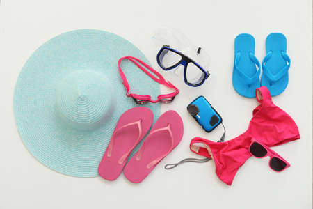 Set of beach accessories on white background