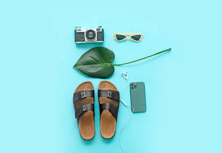 Set of beach accessories with photo camera on color backgroundの写真素材
