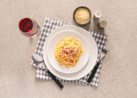 Plate with tasty pasta carbonara on gray backgroundの写真素材