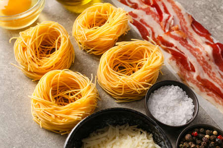 Ingredients for tasty pasta carbonara on gray backgroundの写真素材