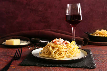 Plate with tasty pasta carbonara on color backgroundの写真素材