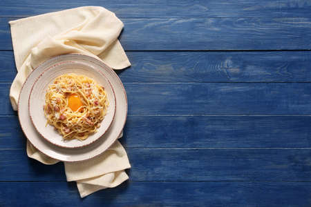 Plate with tasty pasta carbonara on tableの写真素材