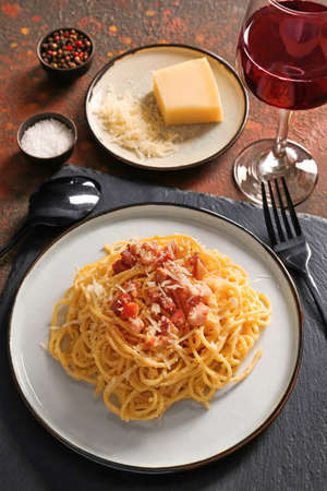 Plate with tasty pasta carbonara on tableの写真素材