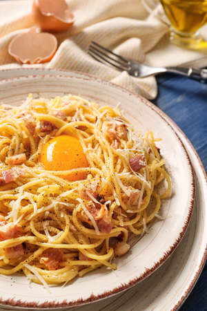 Plate with tasty pasta carbonara on tableの写真素材