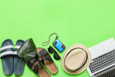 Laptop with beach accessories on color backgroundの写真素材