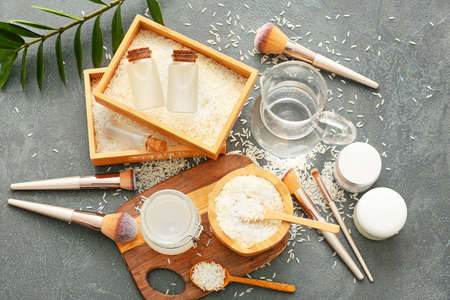 Healthy rice water with cosmetic supplies on dark backgroundの写真素材