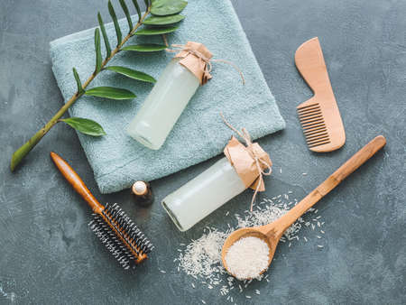 Healthy rice water with cosmetic supplies on dark backgroundの写真素材