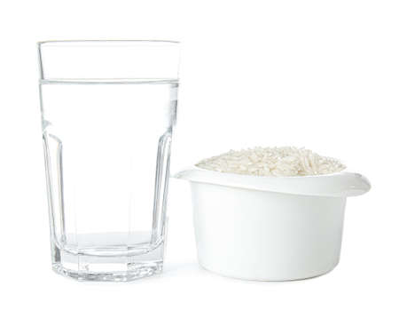 Bowl with rice and glass of water on white backgroundの写真素材