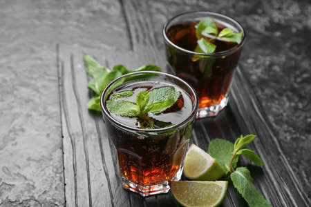 Glasses of tasty Cuba Libre cocktail on tableの写真素材