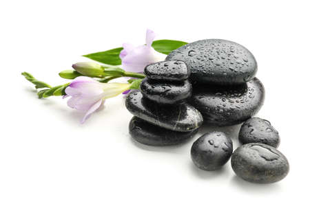 Spa stones and flowers on white backgroundの写真素材