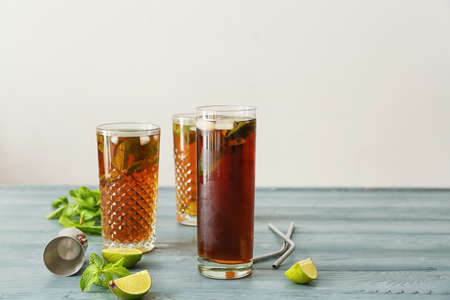 Glasses of tasty Cuba Libre cocktail on table