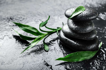 Spa stones and bamboo leaves on dark backgroundの写真素材