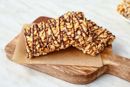 Board with crispy rice bars on tableの写真素材