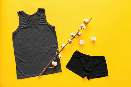 Cotton clothes on color background