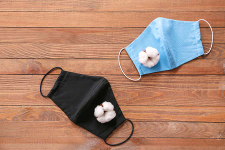 Cotton protective masks on wooden background