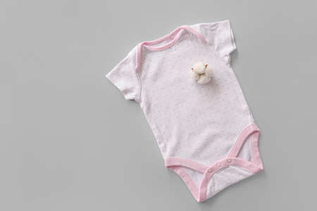 Cotton baby clothes on gray backgroundの写真素材