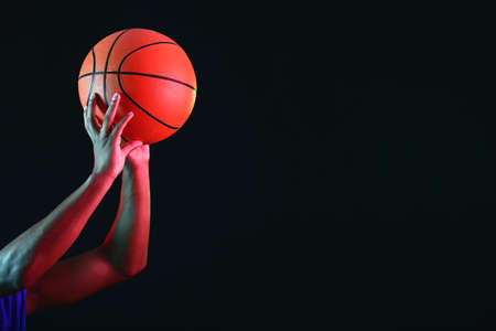 Young African-American basketball player on dark backgroundの写真素材