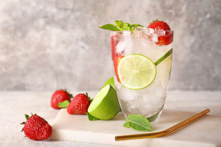 Glass of fresh strawberry lemonade on tableの写真素材