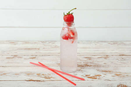 Bottle of fresh strawberry lemonade on tableの写真素材