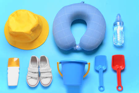 Flat lay composition with child beach accessories on color background. Travel concept
