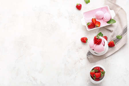 Tasty strawberry ice cream on light background