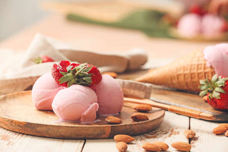 Plate with tasty strawberry ice cream on tableの写真素材