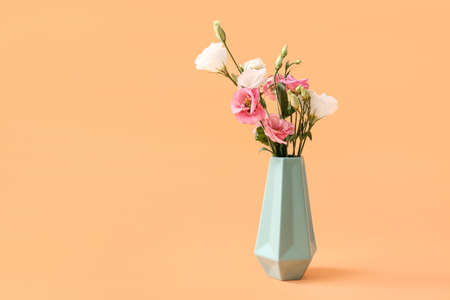Beautiful vase with flowers on color backgroundの写真素材