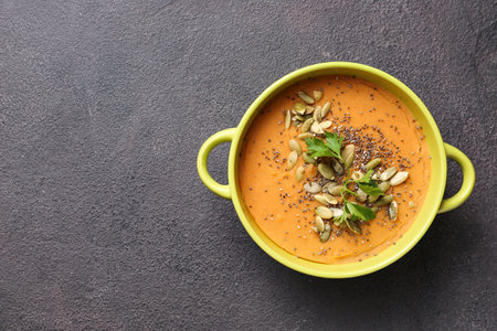 Pot of tasty lentils soup on dark backgroundの写真素材