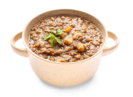 Pot of tasty lentils soup on white backgroundの写真素材