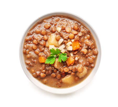 Bowl of tasty lentils soup on white backgroundの写真素材