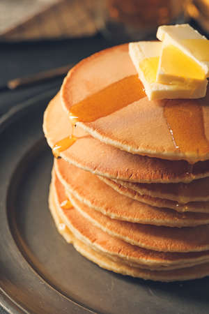 Tasty pancakes with butter and honey, closeup