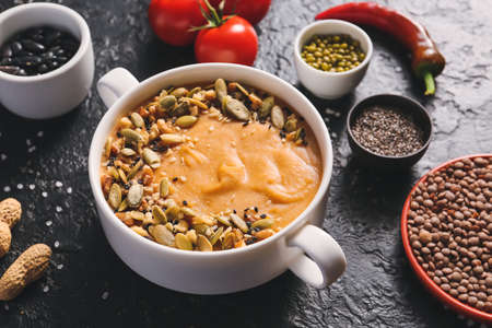 Pot of tasty lentils soup on dark backgroundの写真素材