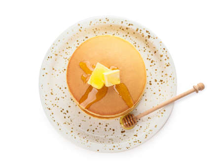 Tasty pancakes with honey and butter on white background