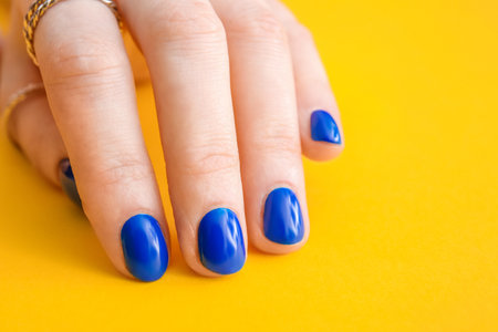 Hand with beautiful manicure on color background, closeupの写真素材