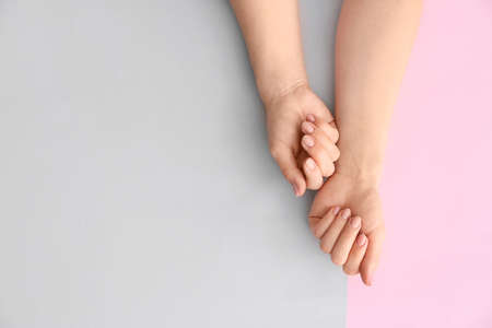Hands with beautiful manicure on color backgroundの写真素材