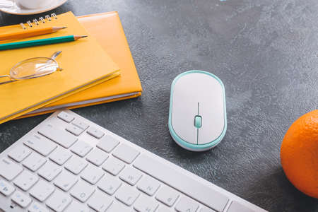 Modern PC mouse, keyboard and stationery on table, closeup
