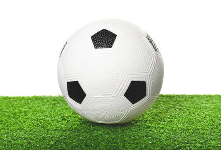 Soccer ball on green field against white backgroundの写真素材